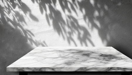 white marble table with tree shadow on concrete wall texture background suitable for product presentation backdrop display and mock upの素材