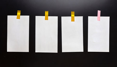 handcopy medium format paper sheet with empty frames fixed by sticker tape on black background cool photo placeholderの素材