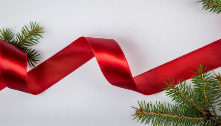 a red christmas ribbon on a white backgroundの素材