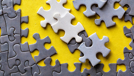 pieces of jigsaw puzzle on yellow backgroundの素材