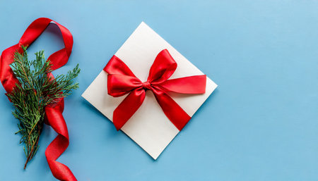blank gift card with red bow on light blue background top view space for textの素材