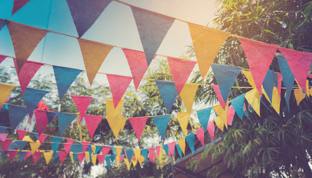 blur background colorful triangular flags of decorated celebrate outdoor party vintage toneの素材