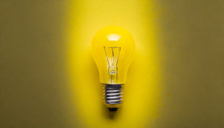 yellow light bulb with yellow backgroundの素材