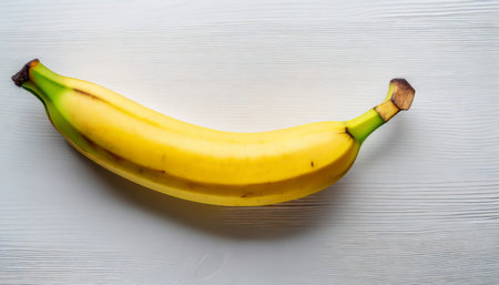 single banana against white background flat lay top viewの素材