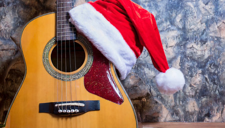 rockin christmas gift vintage acoustic guitar with santa claus hatの素材