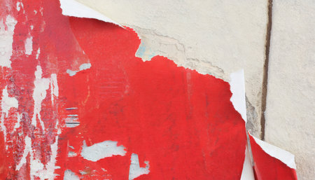 red torn poster on the wallの素材