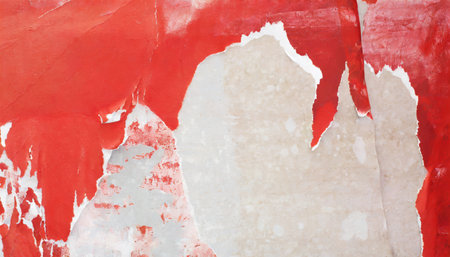 red torn poster on the wallの素材