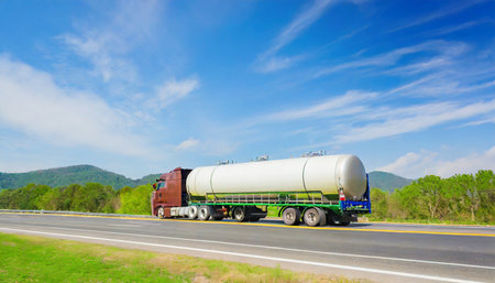large tanker truck hauling on highwayの素材