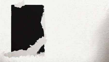 black torn poster on a white wallの素材