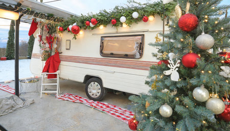 festive trailer christmas yuletide tree backdrop for camper van mobile home and terrace celebrations during winter holidays and new year s day in the campの素材
