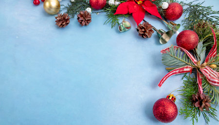 festive christmas decorations creating a vibrant holiday border on blue background celebratory moodの素材