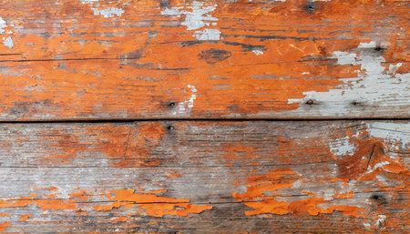 old wood plank with peeled orange paint rough and weathered wood surfaceの素材