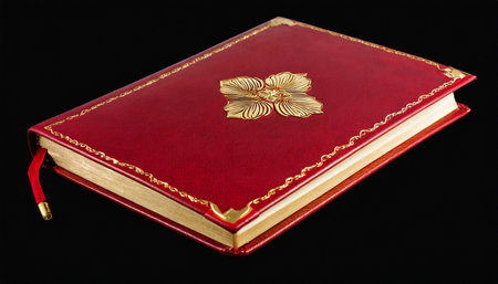 red leather cover of elegant journal with gilded pages captured isolatedの素材