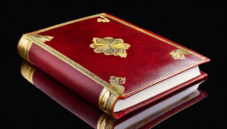 red leather cover of elegant journal with gilded pages captured isolatedの素材