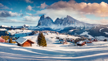 panoramic morning view of alpe di siusi village majestic winter sunrise in dolomite alps superb landscape of ski resort ityaly europe beauty of nature concept backgroundの素材