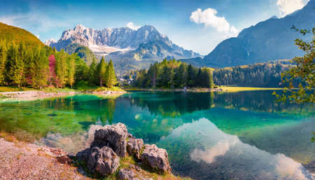 colorful summer view of fusine lake bright morning scene of julian alps with mangart peak on background province of udine italy europeの素材