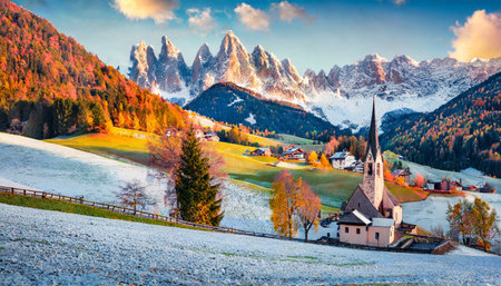 snowy hills on santa magdalena village with seceda peak on background majestic autumn scene of dolomite alps italy superb mrning view of popular tourist destination santa maddalena churchの素材