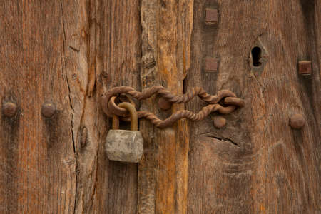 padlock on an old wooden doorの写真素材