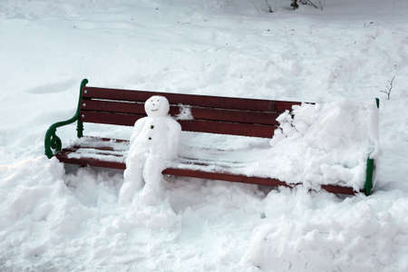 snowman sitting on the benchの写真素材