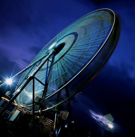 A moving Ferris wheel in the eveningの写真素材