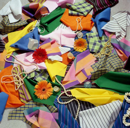 A selection of pieces of fabric and fresh flowersの写真素材