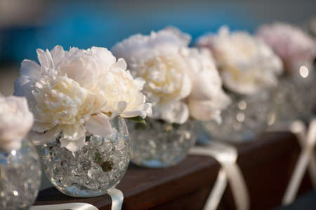 Pink flowers wedding decorations. Beautiful peonies in vasesの写真素材