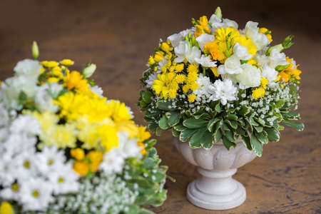 Wedding reception centerpiece close-up with pastel yellow and whiteの写真素材