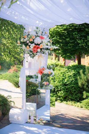 Wedding reception centerpiece close-up with pastel orange and whiteの写真素材