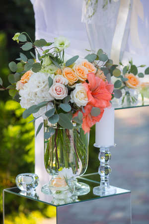 Wedding reception centerpiece close-up with pastel orange and whiteの写真素材
