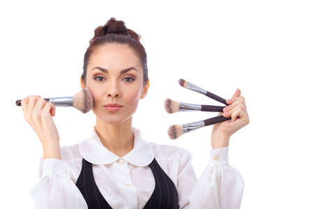 Beauty Girl with Makeup Brushes. Natural Make-up for Brunette Woman with Brown Eyes. Beautiful Face....