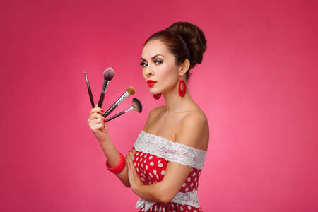 Beauty Girl with Makeup Brushes. Natural Make-up for Brunette Woman. Beautiful Face. Makeover....