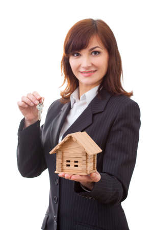 business, real estate and banking concept - smiling businesswoman with house keys and houseの写真素材