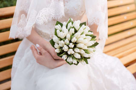 Beautiful wedding bouquet in hands of the bride