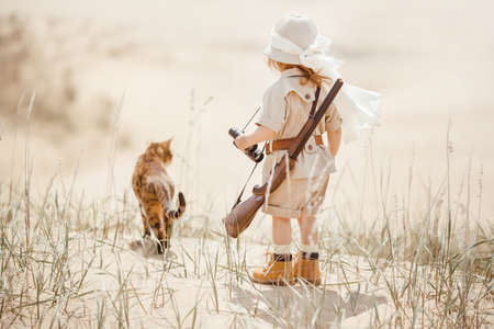 Concept of travel and fascinating adventures. hild in suit of treasures seeker like Indiana Jones in...
