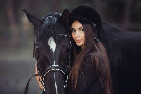 Beautiful young girl smile at her horse dressing uniform competition: outdoors portraitの写真素材