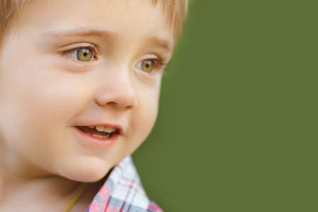 Cute little boy playing outdoor on the nature. Close-up portrait