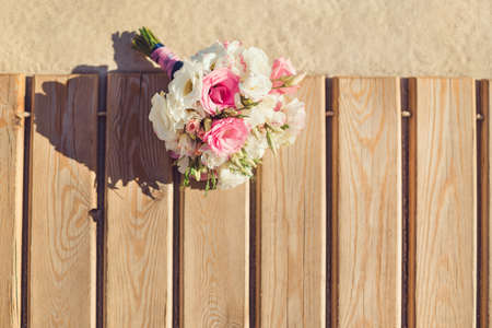 Bride's Pink and White Bouquet Laying on Pier. Wedding in Tropical Country Ideaの写真素材