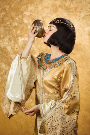 Fashion Stylish Beauty Portrait Holding and Drinking Cup. Beautiful Girl's Face Close-up.