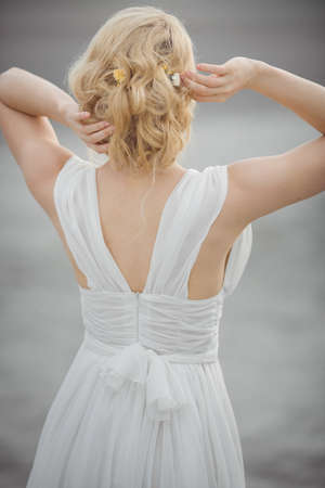 Back-view bridal hair style. Beautiful bride in white dress.の写真素材