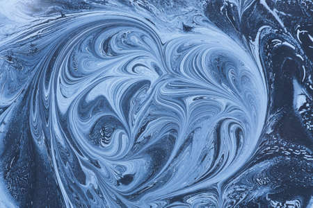 Heart shape fractal. Creative ebru background with abstract acrylic painted waves. Beautiful marbling texture. Handmade marble surface. Blue and yellow colors.の写真素材
