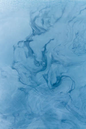 Creative ebru background with abstract acrylic painted waves. Beautiful marbling texture. Handmade marble surface. Blue and yellow colors.の写真素材