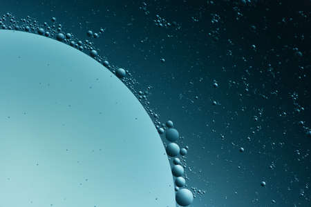 Abstract oil bubbles light illumination background, art of water bubbles on water surface background. Abstract glare on bubbles and watery backgroundの写真素材