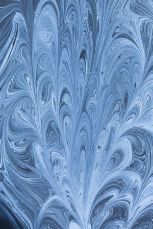 Creative ebru background with abstract acrylic painted waves. Beautiful marbling texture. Handmade marble surface. Blue and yellow colors.の写真素材