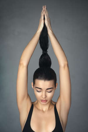 Brunette fashion attractive girl holding and pull a ponytail. Profile of beautiful mixed race Asian...