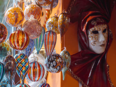 Colorful souvenirs from the famous murano glass. Venetian masks in store display in Venice. Annual carnival in Venice is among the most famous in Europe. Its symbol is the Venetian maskの写真素材