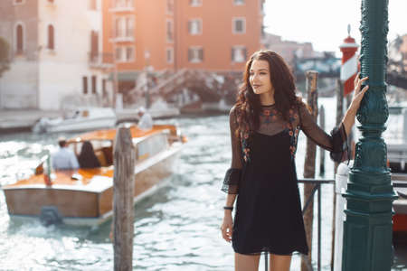 Travel tourist girl on vacation walking happy by Grand Canal.