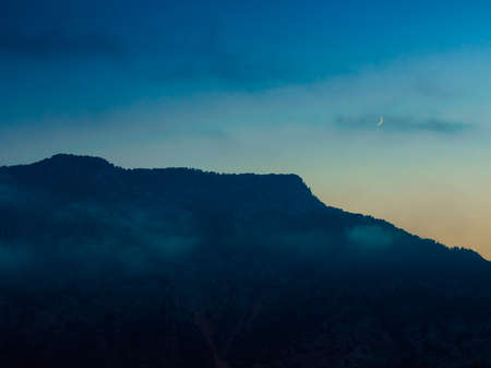 Abstract mountain background at night with copy space- concept of tourism and travel. Layers of ridges in Tunektepe Teleferik near Anntalia at sanrise skyの写真素材