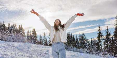 Woman in Winter Clothes Raised Hands Outdoors in Forest
