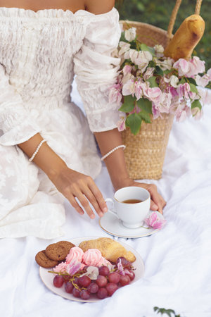 Beautiful Outdoor Bridal Picnic with Cup of Tea in Retro Styleの写真素材