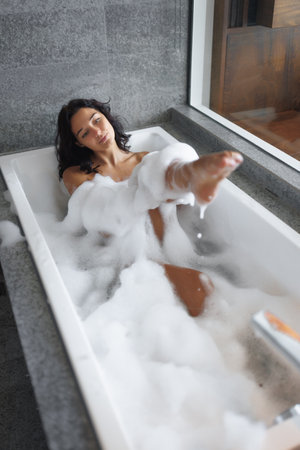 Spa Procedures and Bathing of Young Adult Woman Indoors